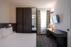 Postel nebo postele na pokoji v ubytování Hotel Ovest