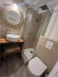 a bathroom with a shower and a toilet and a sink at Confort et évasion à l'Almanarre in Hyères +23 photos