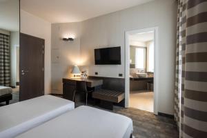 Postel nebo postele na pokoji v ubytování Hotel Ovest