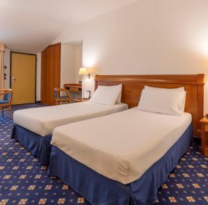 Postel nebo postele na pokoji v ubytování Hotel Ovest