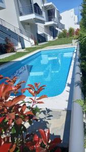 a swimming pool in front of a house at Морска къща ИРИДА in Ofrínion +6 photos