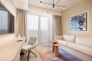a living room with a couch and a table at Baltic Park Loft by Zdrojowa in Świnoujście