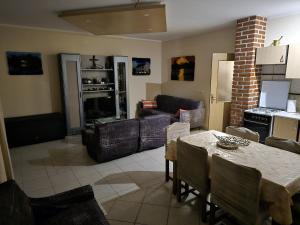 a living room with a table and a couch at Kuća za odmor EDEN in Cernik