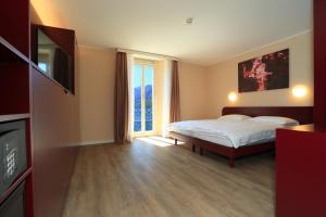 Postel nebo postele na pokoji v ubytování Hotel Elvezia Ascona