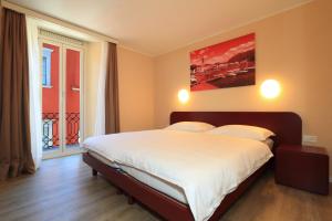 Postel nebo postele na pokoji v ubytování Hotel Elvezia Ascona