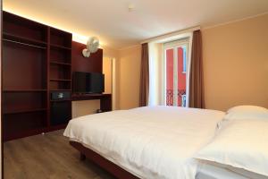 Postel nebo postele na pokoji v ubytování Hotel Elvezia Ascona
