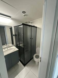 a bathroom with a glass shower and a toilet at GRU Airport 4km, 2 Dorms, Bosque Maia in Guarulhos