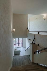 a room with a staircase and a couch in a house at Хотел Арбанашко село in Arbanasi