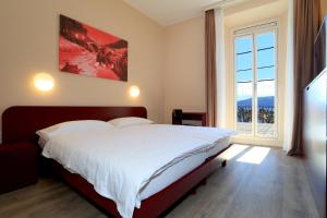 Postel nebo postele na pokoji v ubytování Hotel Elvezia Ascona