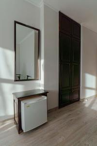 a room with a mirror and a dresser and a door at Хотел Арбанашко село in Arbanasi +36 photos