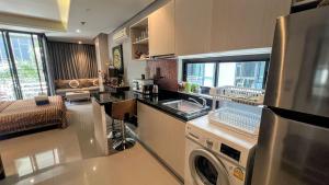 a kitchen with a washer and dryer in a room at Relife Windy by Nataly in Phuket Town