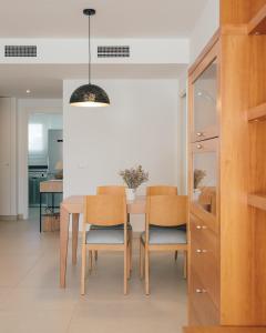 a dining room with a table and chairs at Marina Real I - Casa Areca in Denia