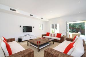a living room with two couches and a tv at Casa Gotmar 132 in El Port