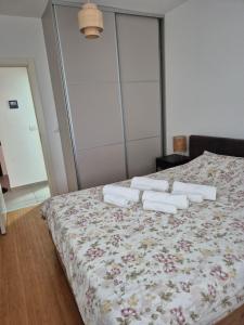 a bedroom with a bed with towels on it at Apartments 402 in Bar
