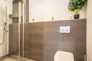 a bathroom with a glass shower with a toilet at Ferienwohnung Lang in Kressbronn am Bodensee +15 photos