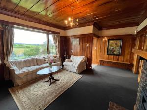 a living room with a couch and a table at Greenwood Homestead in Tarara