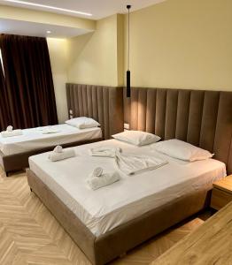 Postel nebo postele na pokoji v ubytování Karos Hotel Llaman