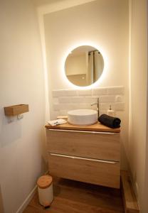 a bathroom with a sink and a mirror at L'Edelweiss - Au pied des montagnes in La Lechere