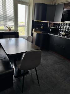a kitchen with a table and chairs in a room at Avangard in Chernivtsi +14 photos