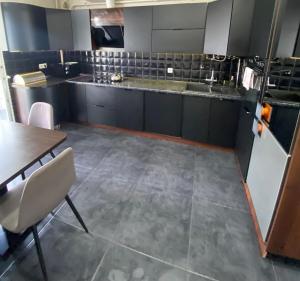 a large kitchen with a table and chairs in it at Avangard in Chernivtsi