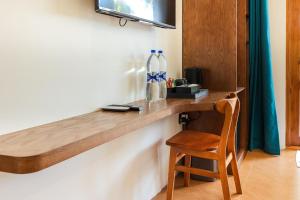 a wooden counter in a room with a wooden chair at The Palms Thoddoo in Thoddoo