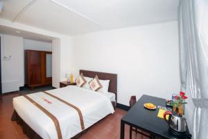 Postel nebo postele na pokoji v ubytování The Rice 131 Bui Vien Hotel