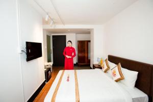 Postel nebo postele na pokoji v ubytování The Rice 131 Bui Vien Hotel