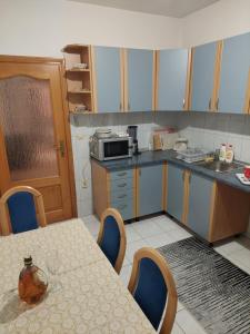 a kitchen with a table and a counter top at Apartman 10 in Bosanski Šamac
