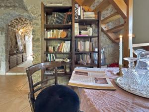 a room with a table and a book shelf with books at Lina's Art and Stone Studio in Verga Kalamata