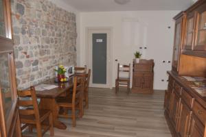 a kitchen and dining room with a table and chairs at Casa Beuzer in Cividale del Friuli +18 photos