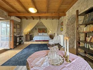 a bedroom with a bed and a table with a candle at Lina's Art and Stone Studio in Verga Kalamata
