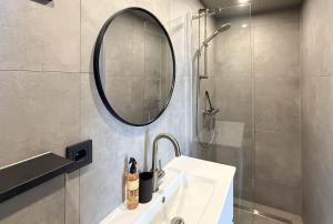 a bathroom with a sink and a mirror and a shower at 't Boschhuys by Droomvilla in Bergen +22 photos