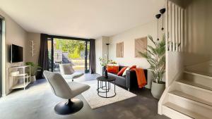 a living room with a couch and a chair at 't Boschhuys by Droomvilla in Bergen