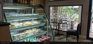 a display case in a bakery with a lot of pastries at Sea Star House in Ao Nang Beach