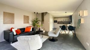 a living room with a couch and chairs and a table at 't Boschhuys by Droomvilla in Bergen