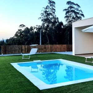 a swimming pool in the yard of a house at Sunny Haven-Villa in Ponte de Lima