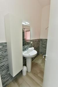 a bathroom with a sink and a mirror at VILLA IRMA in Varigotti