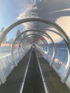 an escalator in a tunnel with people on it at Saunaparadies Black Forest in Löffingen +1 photo