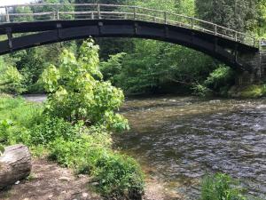 a bridge over a river with water under it at Saunaparadies Black Forest in Löffingen