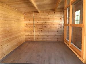 an empty sauna with wooden walls and windows at Saunaparadies Black Forest in Löffingen