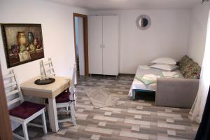 a room with a bed and a table and a desk at Boemul Neptun in Neptun