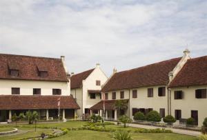 a row of white buildings with red roofs at Wisma Jampea in Makassar