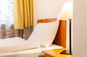 Postel nebo postele na pokoji v ubytování Hotel Oswald