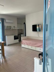 a bedroom with a pink bed and a kitchen at Villa Mertiza in Myrtos +62 photos