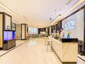 a store lobby with people sitting at a counter at Xana Hotelle·Shenyang North Railway Station Square in Shenyang