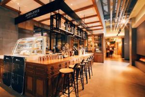 a bar in a restaurant with bar stools at James Joyce Coffetel·Shanghai New International Expo Cente in Shanghai