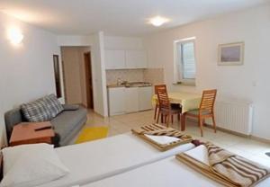 a living room with a couch and a table at Apartments Vlado in Njivice