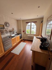 a kitchen with wooden floors and a counter top at Villa face mer - Le Pouliguen in Le Pouliguen +5 photos