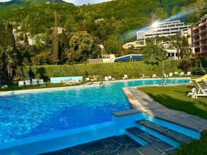 a swimming pool with blue water in a resort at MIRALAGO -Wonderful Lake view in Bissone