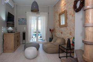 a living room with a couch and a chair at ZANTE STARLET - Chic Hideaway with Pool & Comfort in Lagópodhon